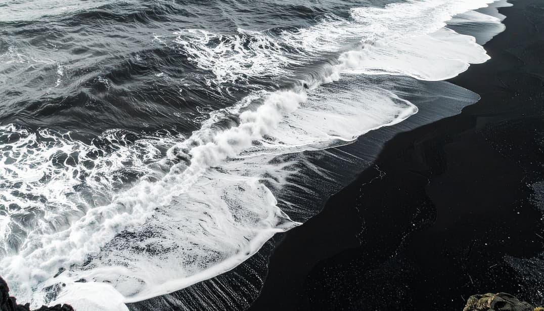 Ocean waves on a Big Island black sand beach