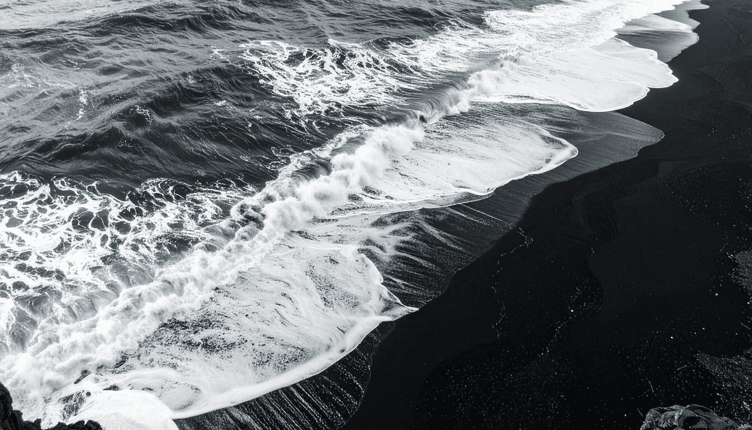 Ocean waves on a Big Island black sand beach